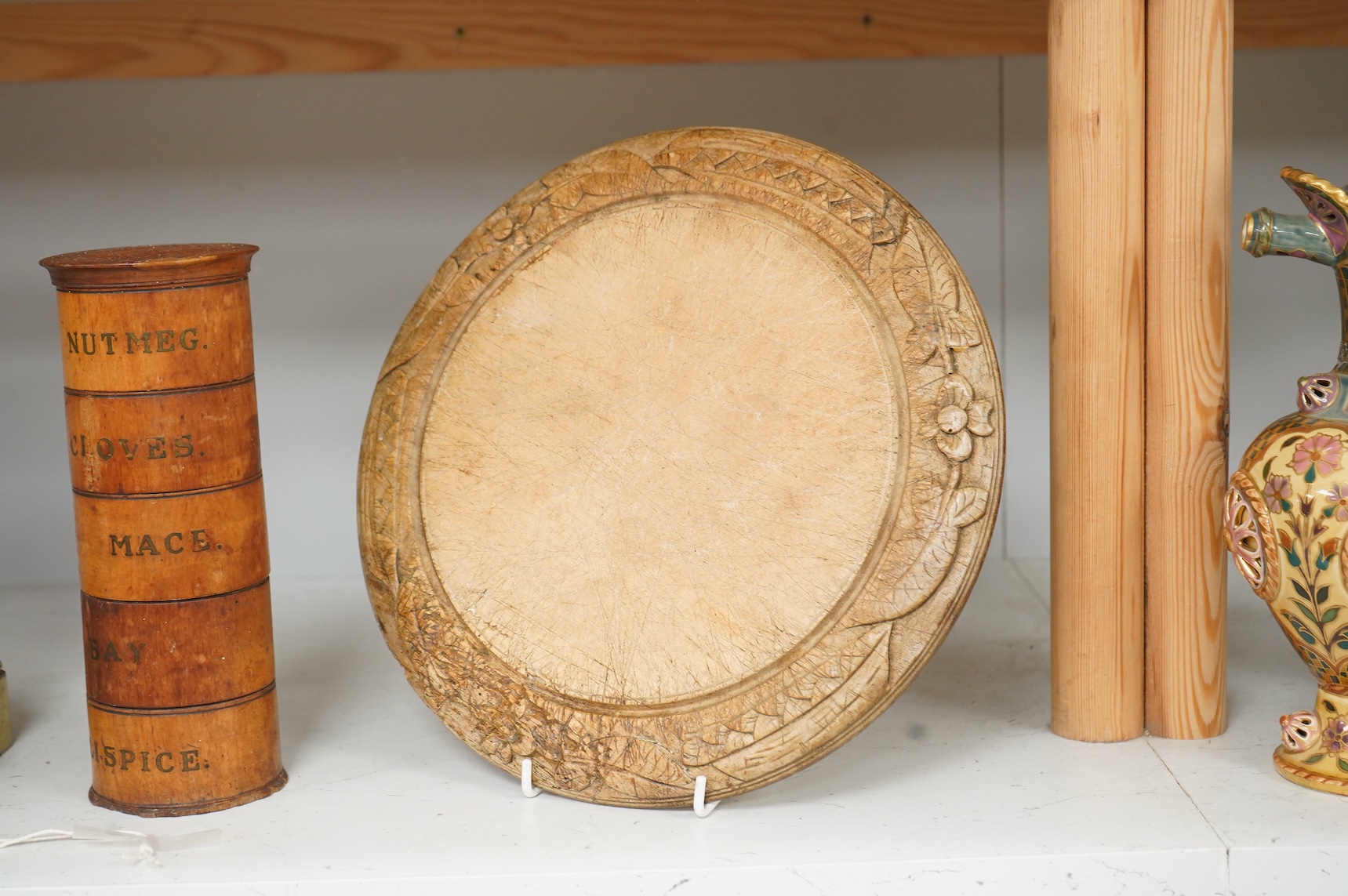 A Victorian treen spice tower and a carved bread board, 30cm in diameter
